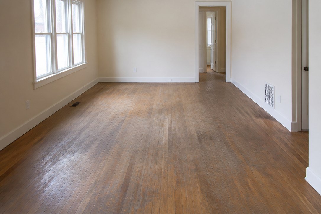 Worn and faded hardwood floor before STN Property Services refinishing