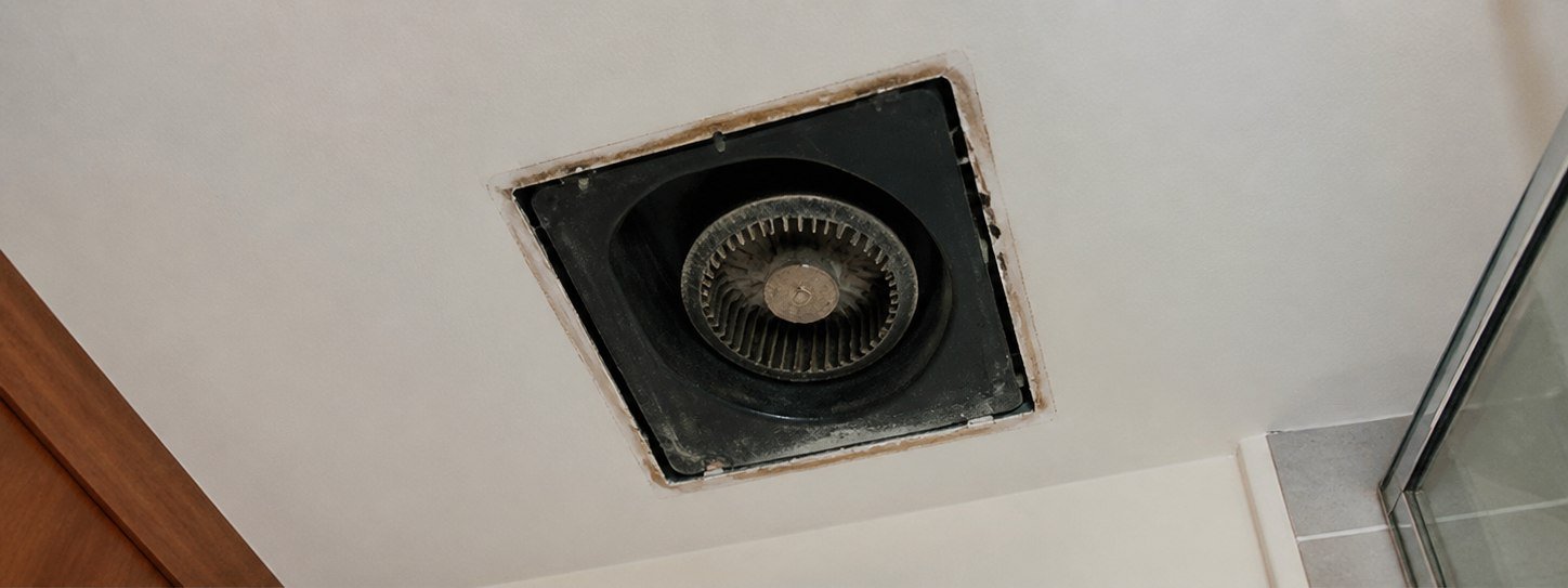 Open ceiling vent with exposed exhaust fan before STN Property Services service